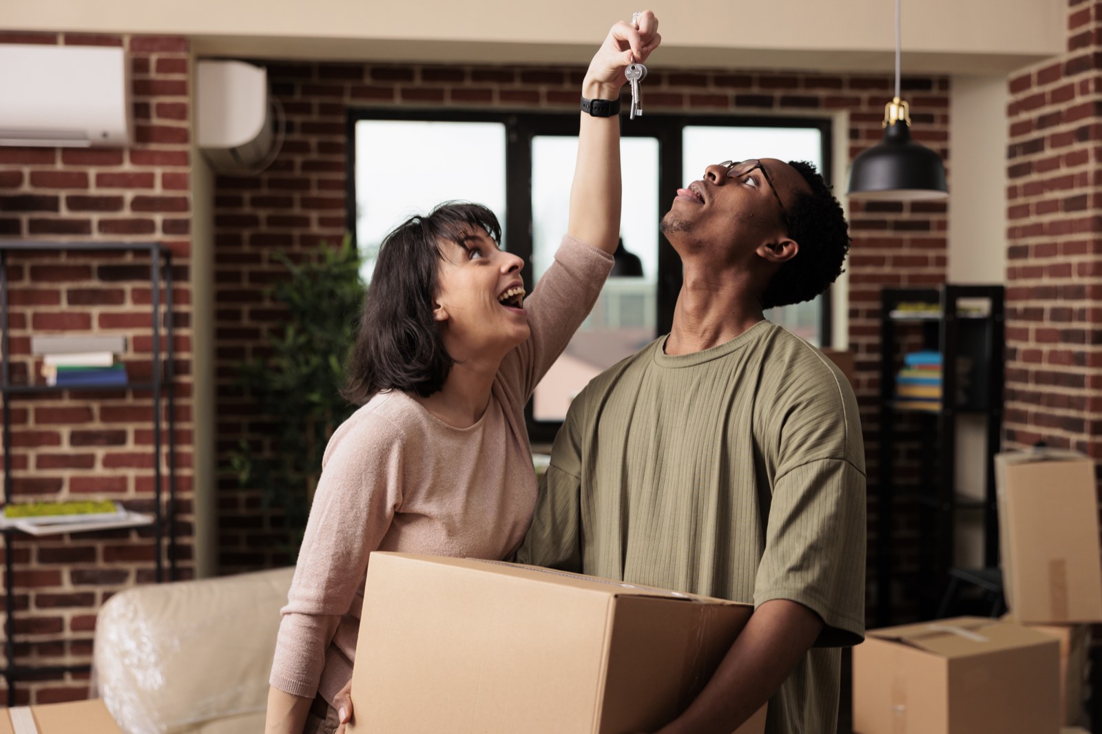 Happy couple holding keys to their home