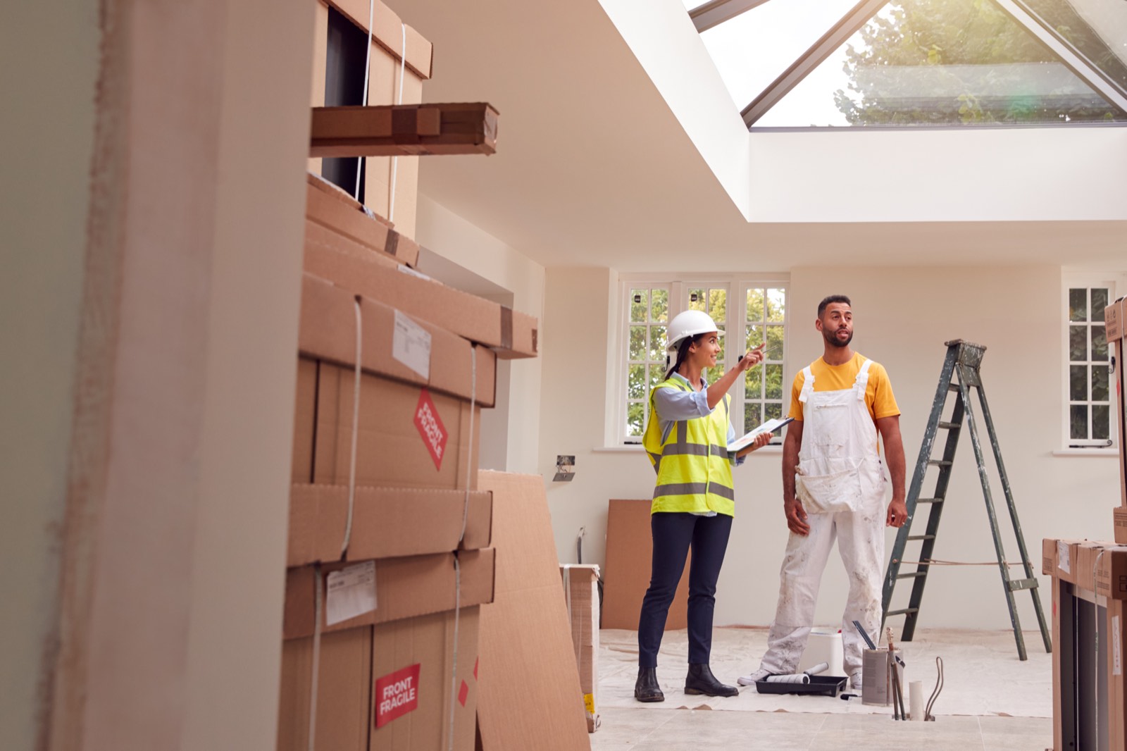 Surveyor and decorator inspecting a newly renovated room